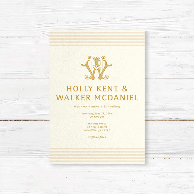 Elegant cream and gold wedding invitation featuring a decorative gold monogram crest at the top, horizontal neutral stripes on the top and bottom edges, and classic serif typography, ideal for formal weddings.