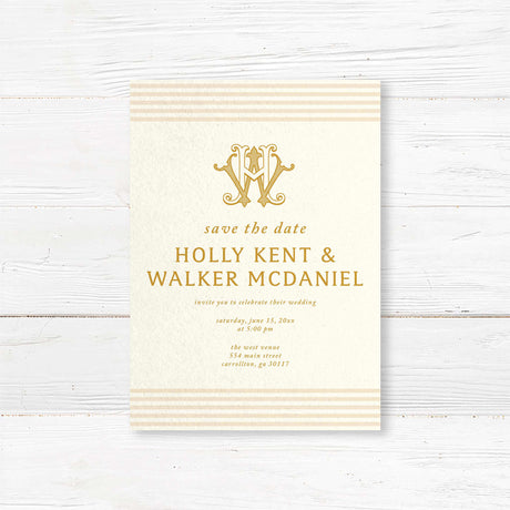 Save the Date card with gold serif text, cream background, neutral stripe accents, and decorative monogram—part of a coordinated gold wedding invitation suite.