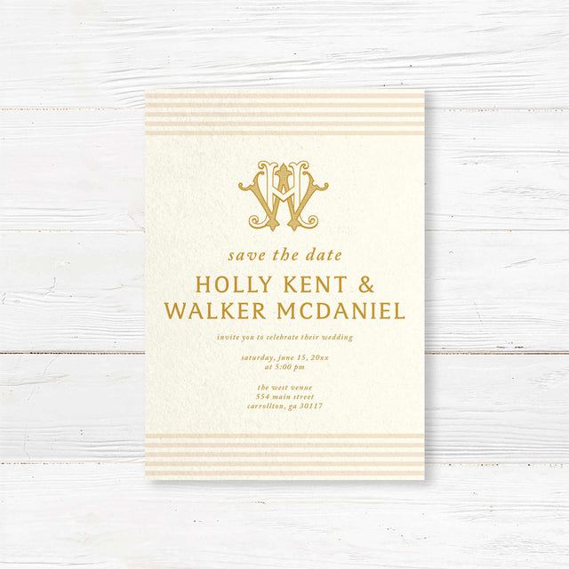 Save the Date card with gold serif text, cream background, neutral stripe accents, and decorative monogram—part of a coordinated gold wedding invitation suite.