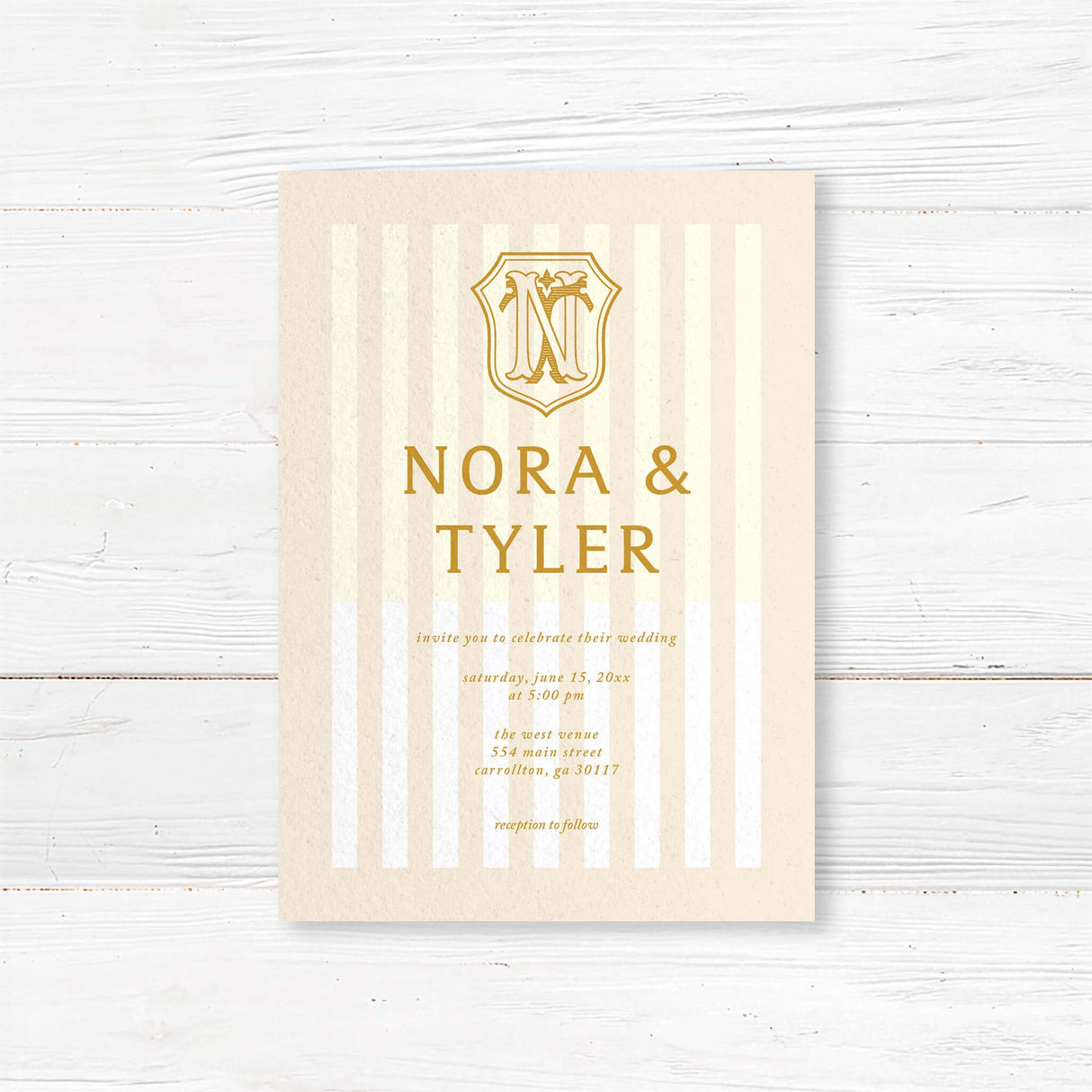 Cream and gold wedding invitation with vertical stripes and vintage-style crest monogram