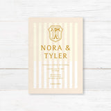 Cream and gold wedding invitation with vertical stripes and vintage-style crest monogram