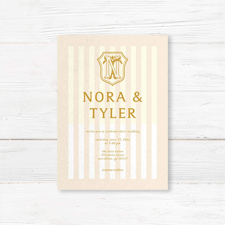 Cream and gold wedding invitation with vertical stripes and vintage-style crest monogram