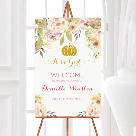 A sweet little pumpkin baby shower welcome sign with floral decorations and a gold pumpkin. The design uses soft pink and green colors.