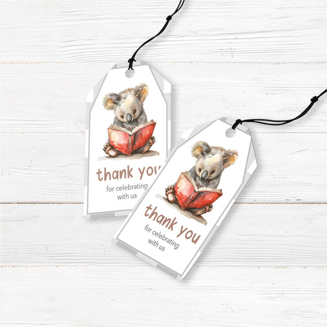 Favor tags featuring a watercolor koala reading a red book, set against a neutral buffalo plaid background. Text reads "Thank you for celebrating with us," with customizable details. Perfect for literary or woodland-themed baby showers and celebrations.