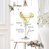 Birthday welcome sign with a watercolor martini glass, green olives, lime, and playful serif and script fonts. Coordinates with a cocktail-themed birthday celebration.