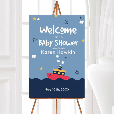 A tugboat baby shower welcome sign with a tugboat illustration on blue water. The design features stars, waves, and playful text.