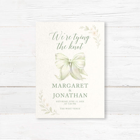 “Tying the Knot” wedding invitation with hand-painted bow and floral accents, professionally printed on textured cardstock