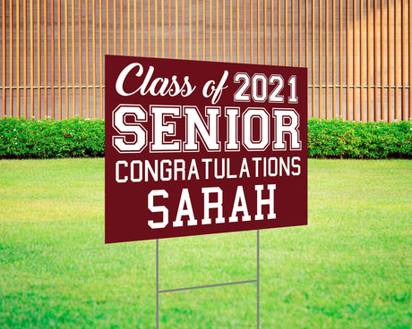 Graduation yard sign featuring bold varsity-style SENIOR lettering, custom class year, and congratulations message. Printed on durable Coreplast plastic, available in custom colors and single or double-sided print, perfect for high school and college graduates. burgundy