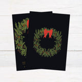 Vintage evergreen wreath Christmas party invitation featuring an evergreen wreath with pinecones, red berries, and a large red bow. Gold lettering appears against a dark background with a coordinating wreath design on the back. - back.