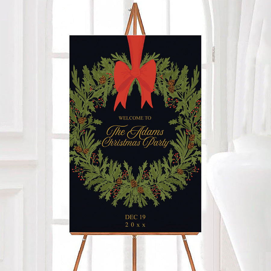 Vintage evergreen wreath Christmas party welcome sign featuring an evergreen wreath with pinecones, red berries, and a large red bow. Gold personalized lettering appears in the center against a dark background.