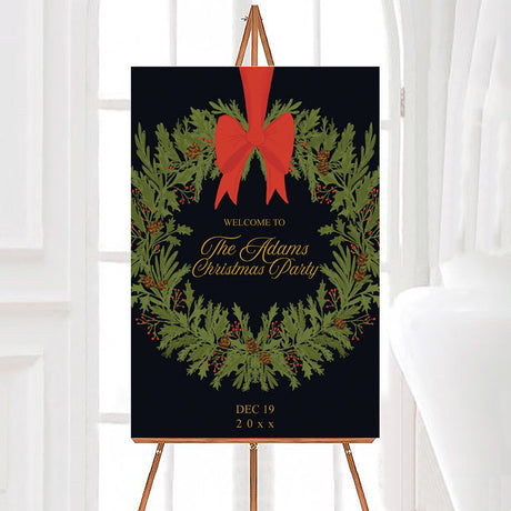Vintage evergreen wreath Christmas party welcome sign featuring an evergreen wreath with pinecones, red berries, and a large red bow. Gold personalized lettering appears in the center against a dark background.