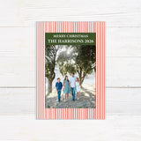 Personalized family Christmas photo card featuring a classic striped border, large family photograph, Merry Christmas greeting, and custom family name. The coordinating back features a decorated Christmas tree framed by matching pinstripes. red