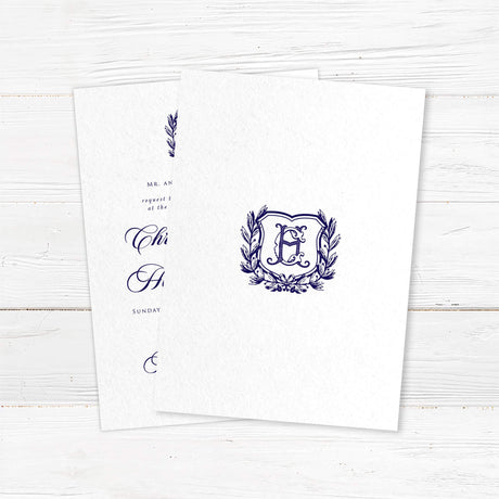 Formal wedding invitation with a vintage-style shield and laurel wreath monogram. Features elegant script for the names and classic serif text for wedding details.- back