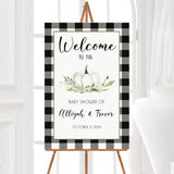 A white pumpkin baby shower welcome sign with a white pumpkin and plaid border. The design features neutral colors and seasonal text.