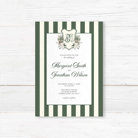 Winter wedding invitation featuring dark green and ivory vertical stripes, a white panel, floral monogram crest with greenery and roses, and elegant script and serif fonts for a formal winter wedding.