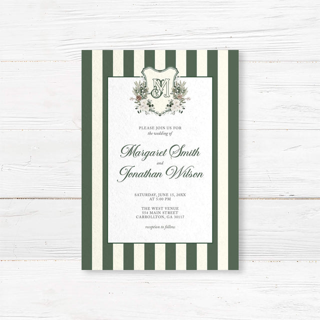 Winter wedding invitation featuring dark green and ivory vertical stripes, a white panel, floral monogram crest with greenery and roses, and elegant script and serif fonts for a formal winter wedding.