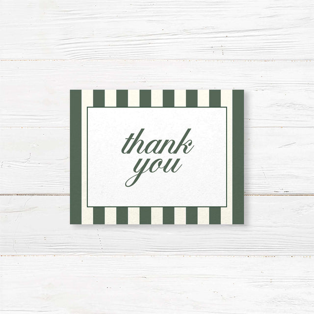 Wedding thank you card with botanical floral crest, vertical green and ivory stripes, and classic fonts for a printed card matching the Winter Crest wedding stationery suite.