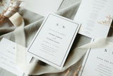 A wedding stationery suite arranged on fabric